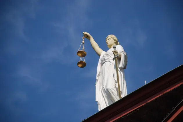 picture of a statue of Lady Justice on a roof of a building