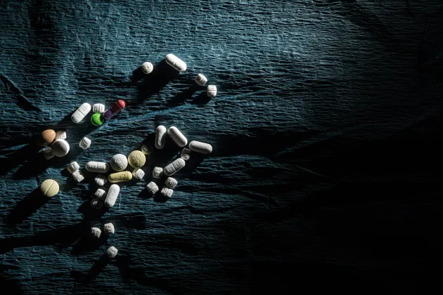 Pills on a dark fabric
