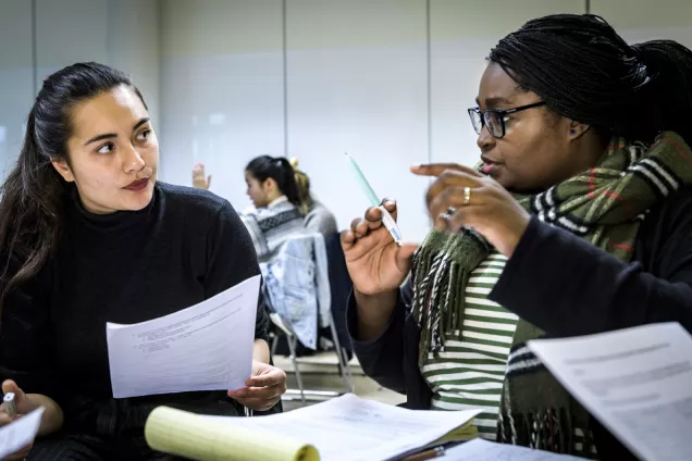 Two students engaged in a conversation. Photo.