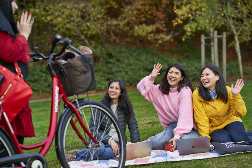 Smiling students in a park. Photo.