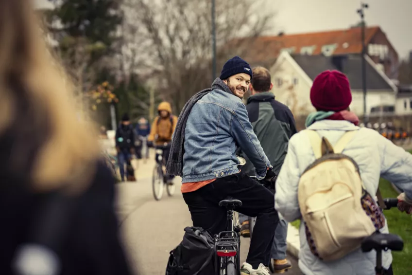 A group of students ride bicycles. Photo.