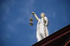 picture of a statue of Lady Justice on a roof of a building