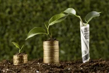 Plants grow from stacks of coins.